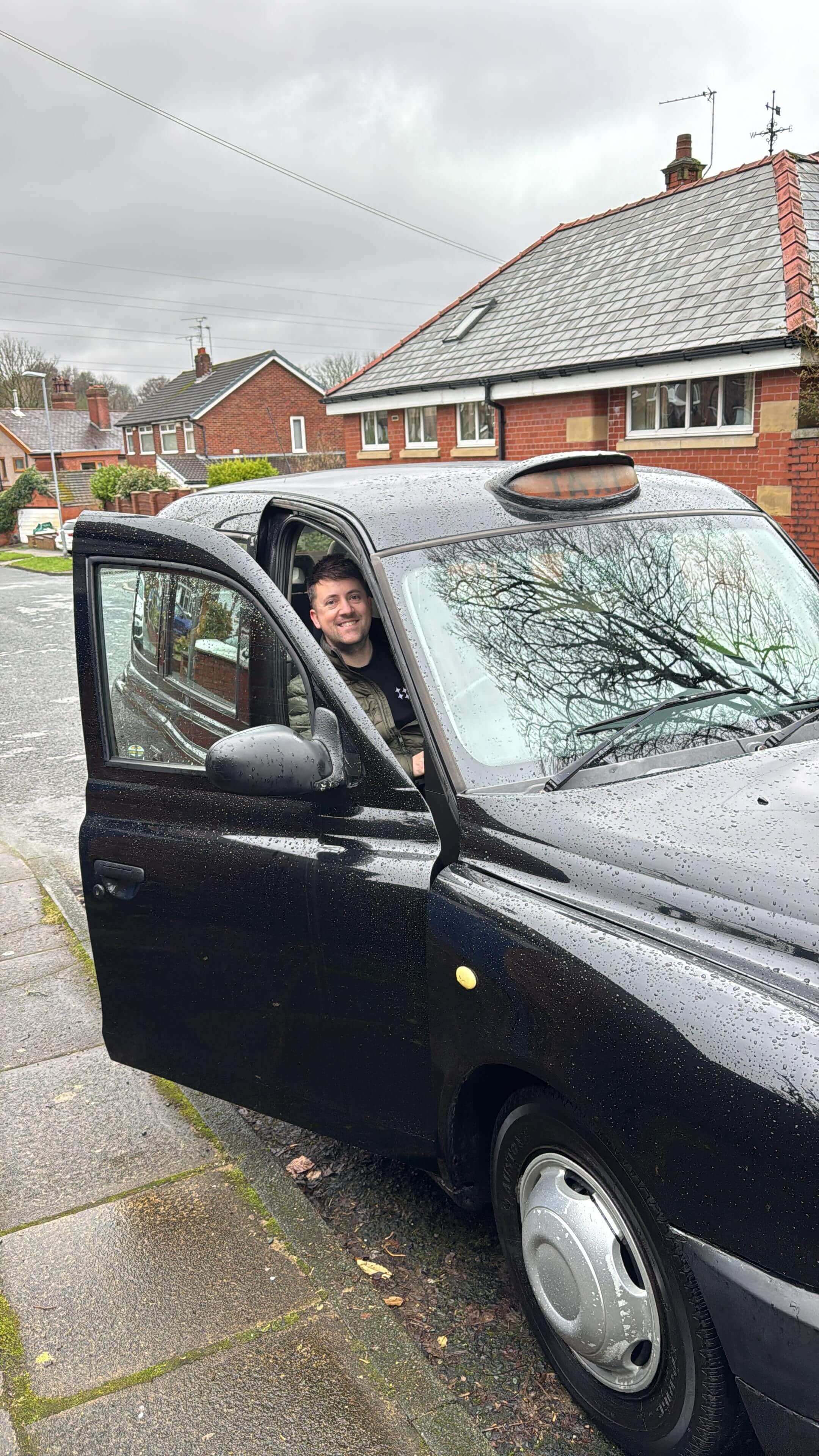 Steve behind the wheel of the taxi